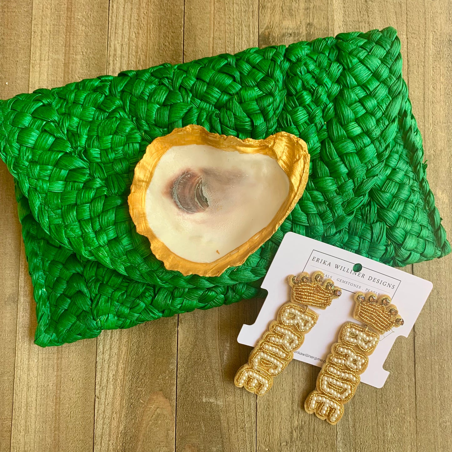 green clutch beside bride earrings