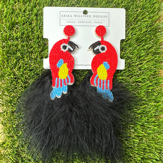 red parrot earrings with yellow and blue accents paired with black feather ending