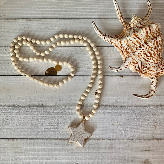 Necklace made out of White Magnesite Beads and it has a Lone Star Shape Pendant