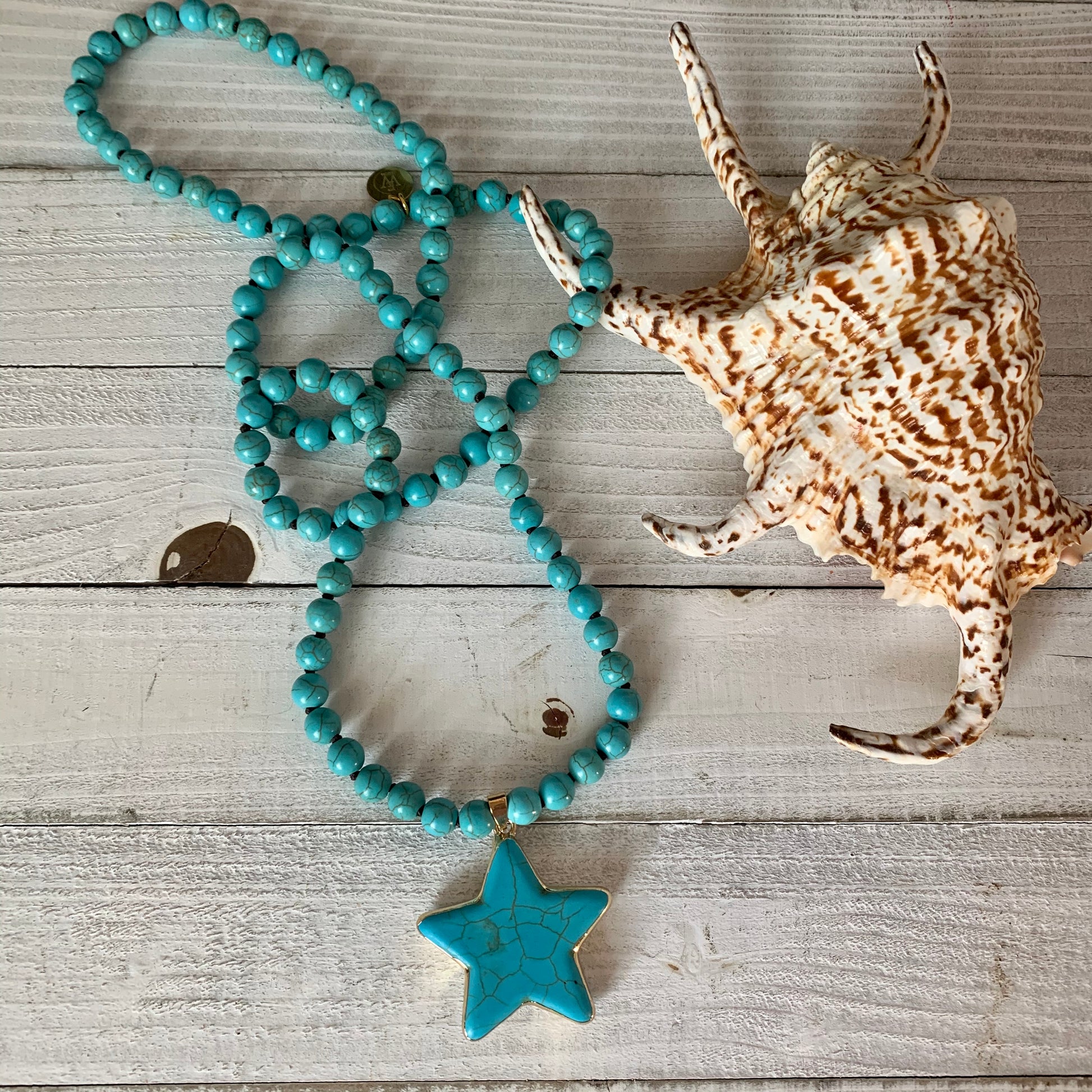 Necklace made out of Turquoise Magnesite Beads and it has a Lone Star Shape Pendant