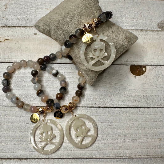 Stretchy 6mm Agate Beads Bracelet featuring an acetate crossed bones and skull charm