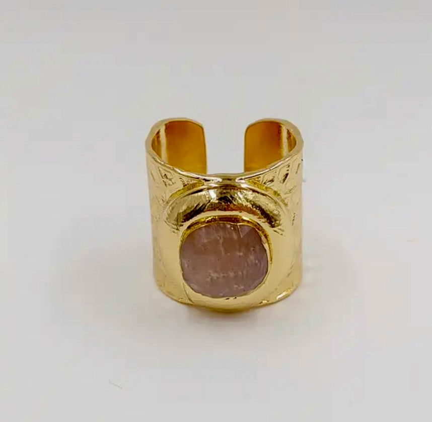 Cuff ring with a faceted stone A