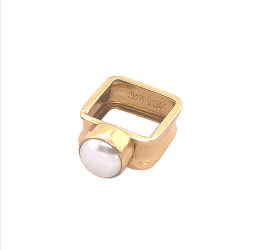 gold ring with bezel set laying flat
