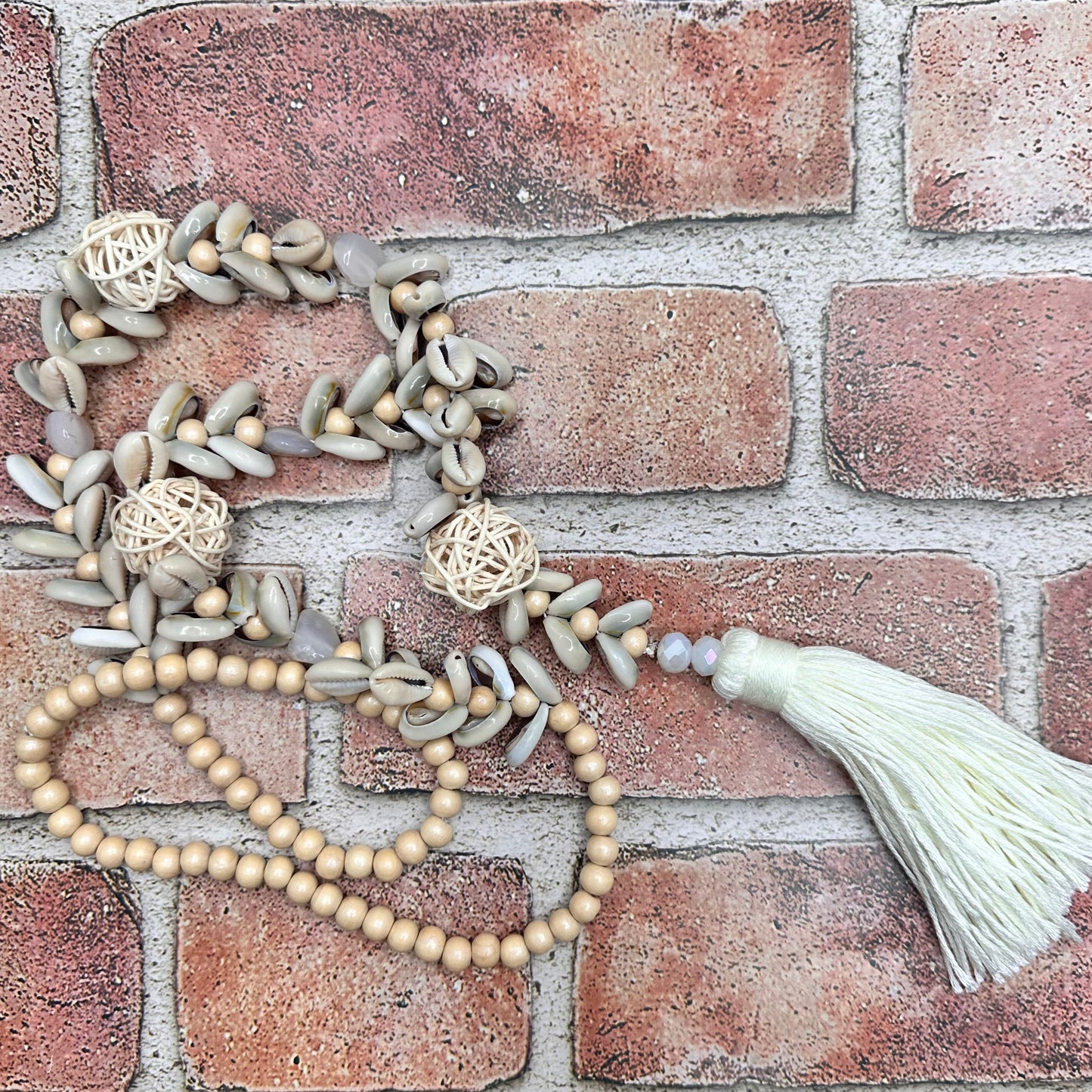 Cowry shells and raffia beads with cotton tassel necklace | Erika Williner Designs