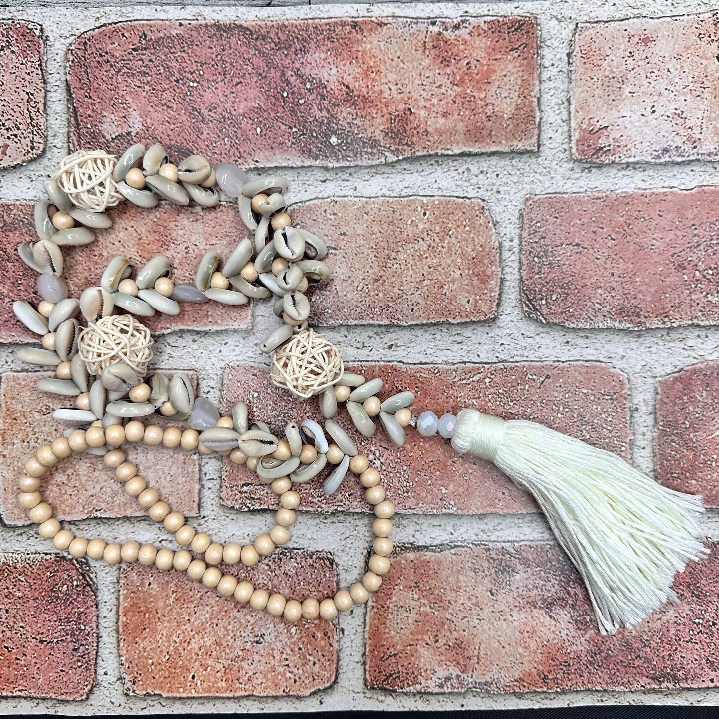 Cowry shells and raffia beads with cotton tassel necklace | Erika Williner Designs