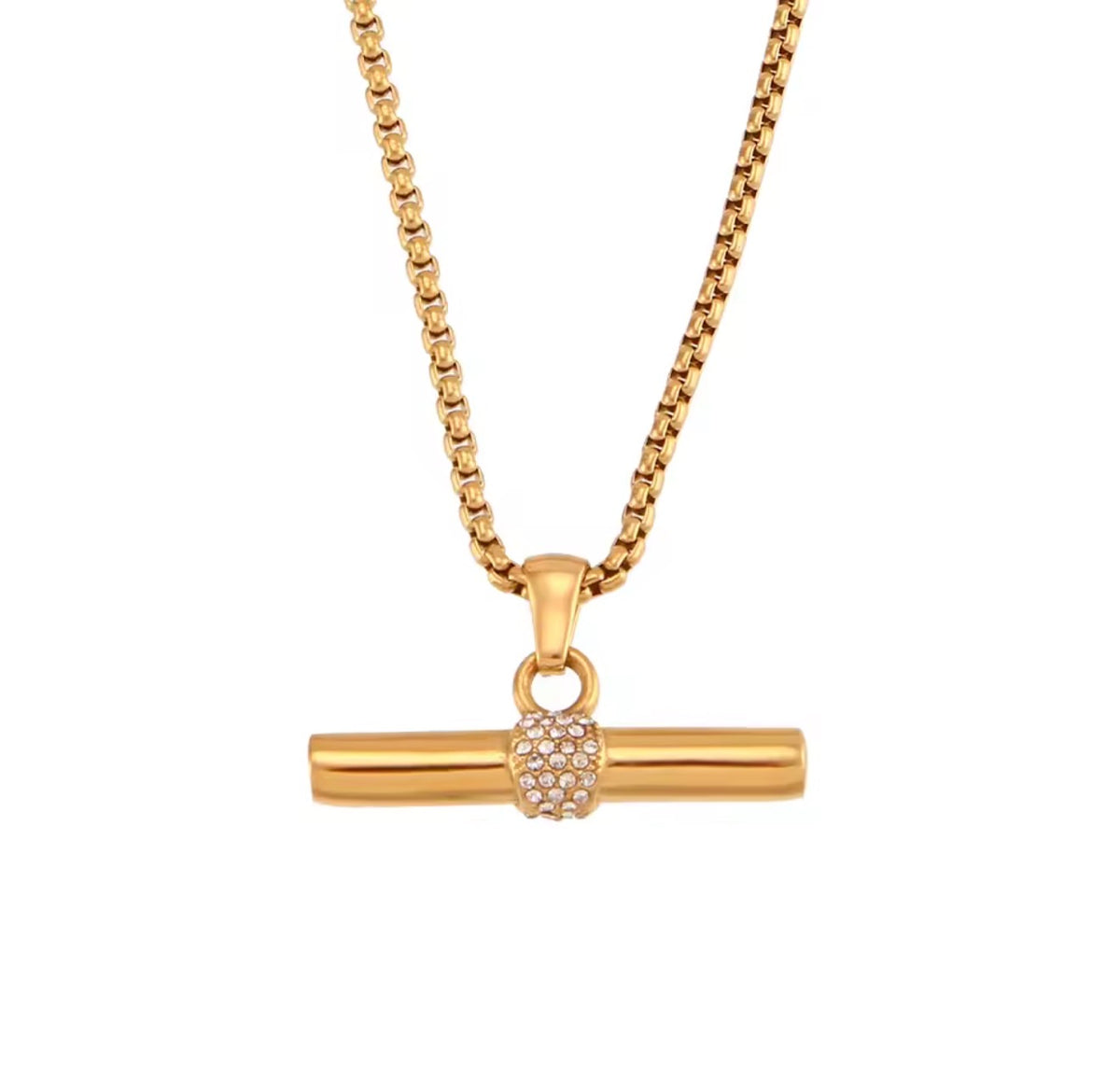 A gold-toned necklace featuring a horizontal bar pendant with a textured, diamond-like pavé center, suspended from a box chain against a plain white background.