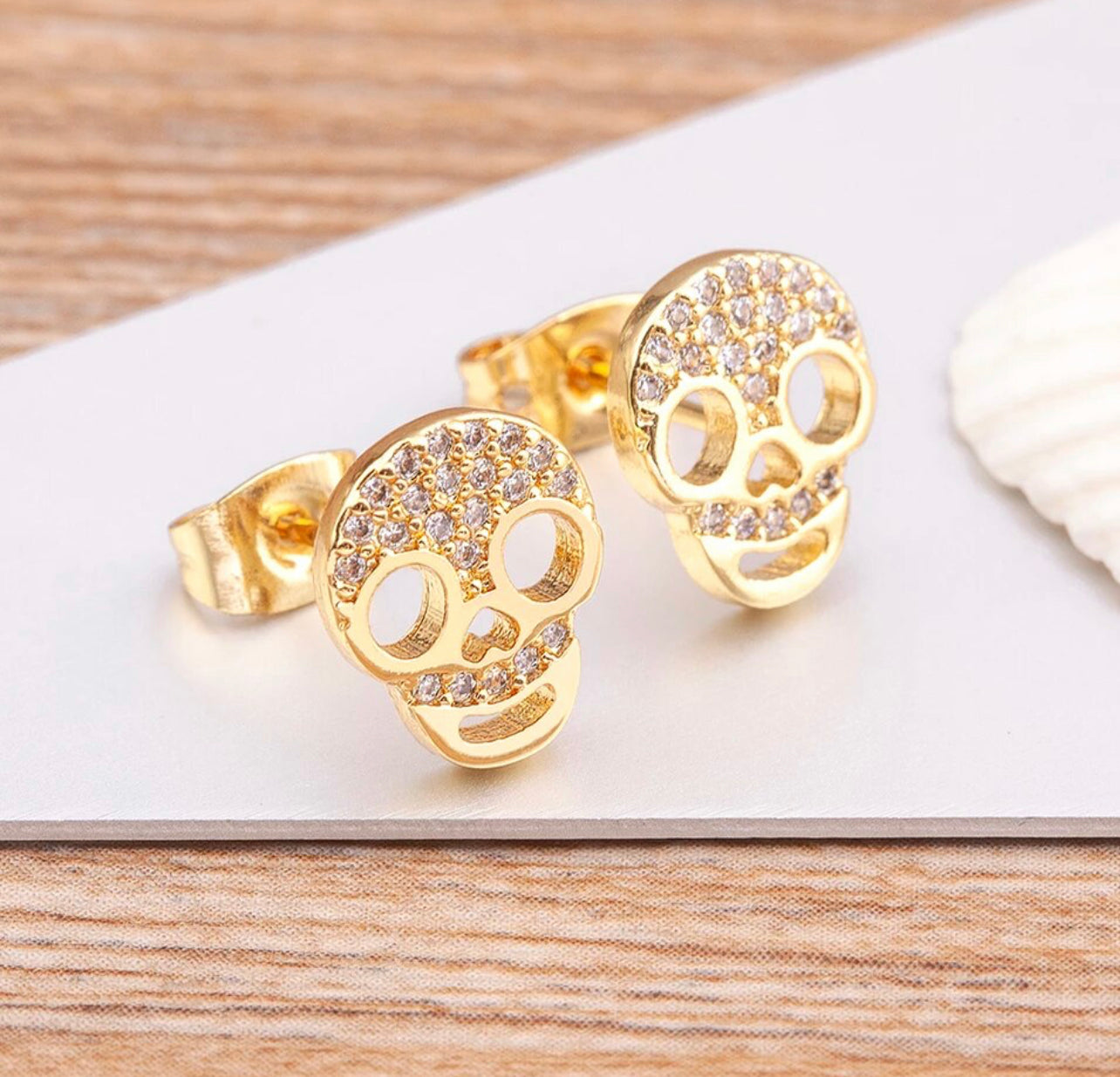 side view of skull pave earrings
