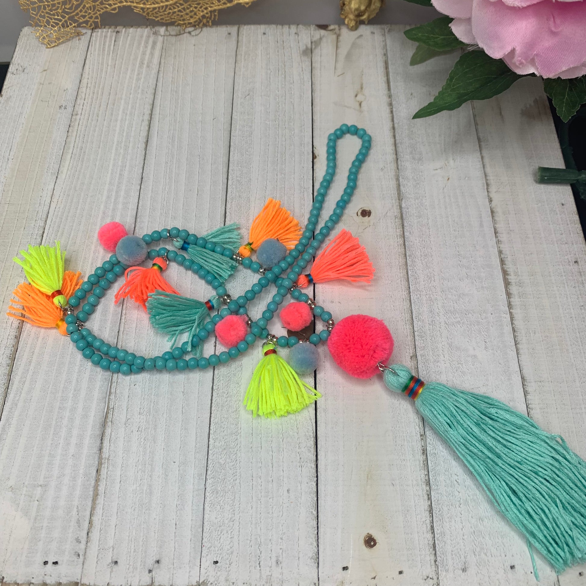 flat lay view of multicolor tassel necklace