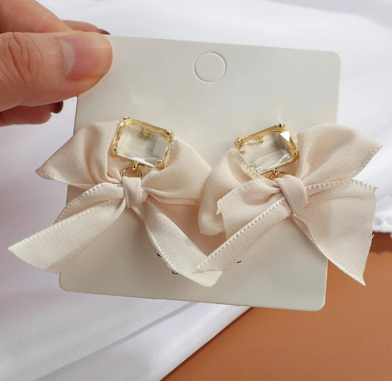 white bow tie earrings