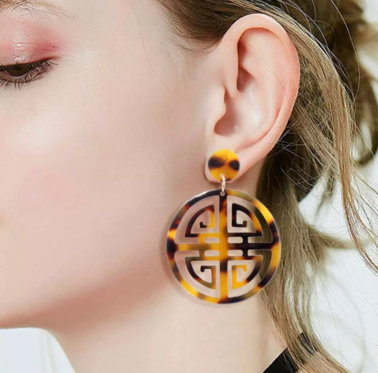 Tortoise shell earrings worn on young lady