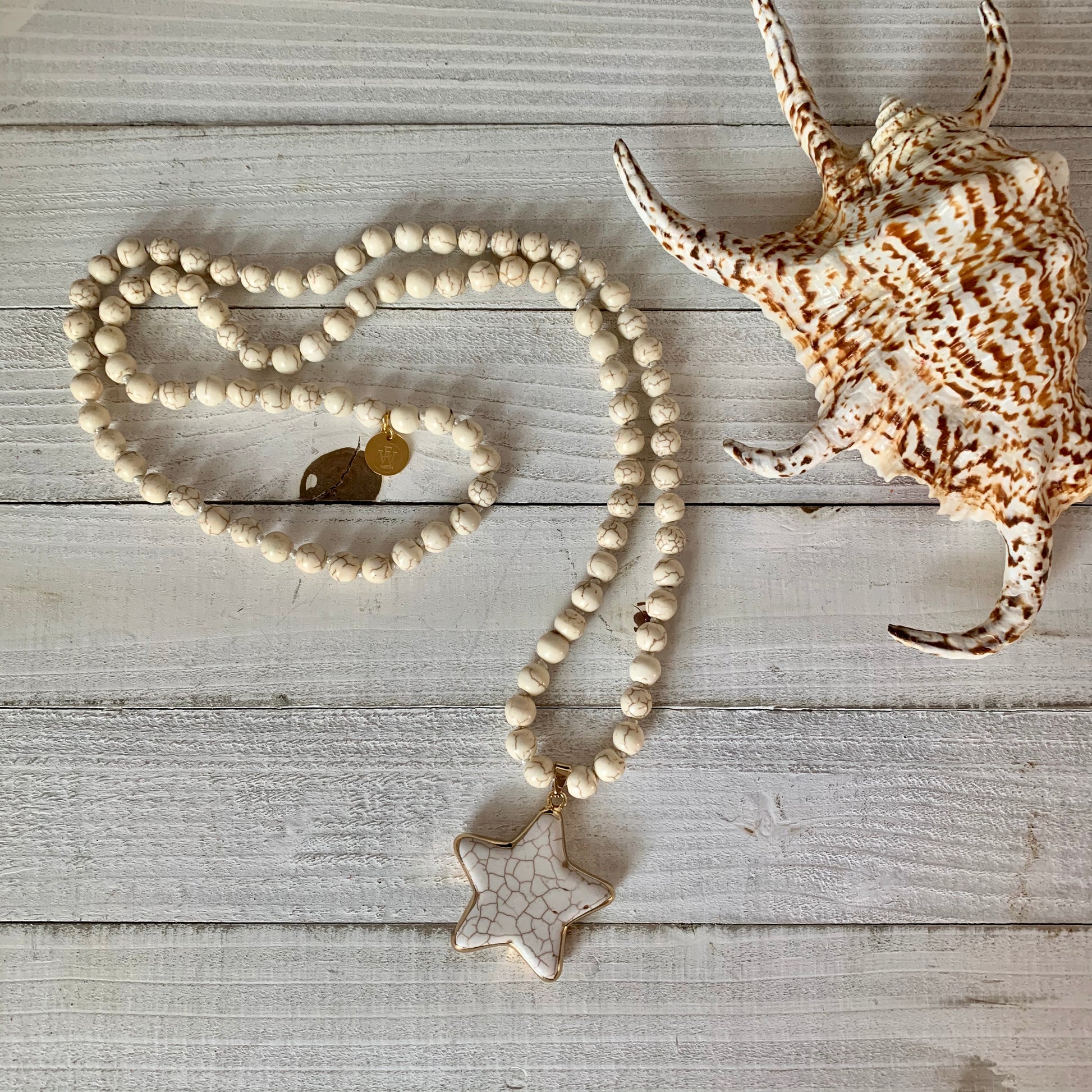 Necklace made out of White  Magnesite Beads and it has a Lone Star Shape Pendant