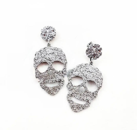 front view of silver hammered skull earrings