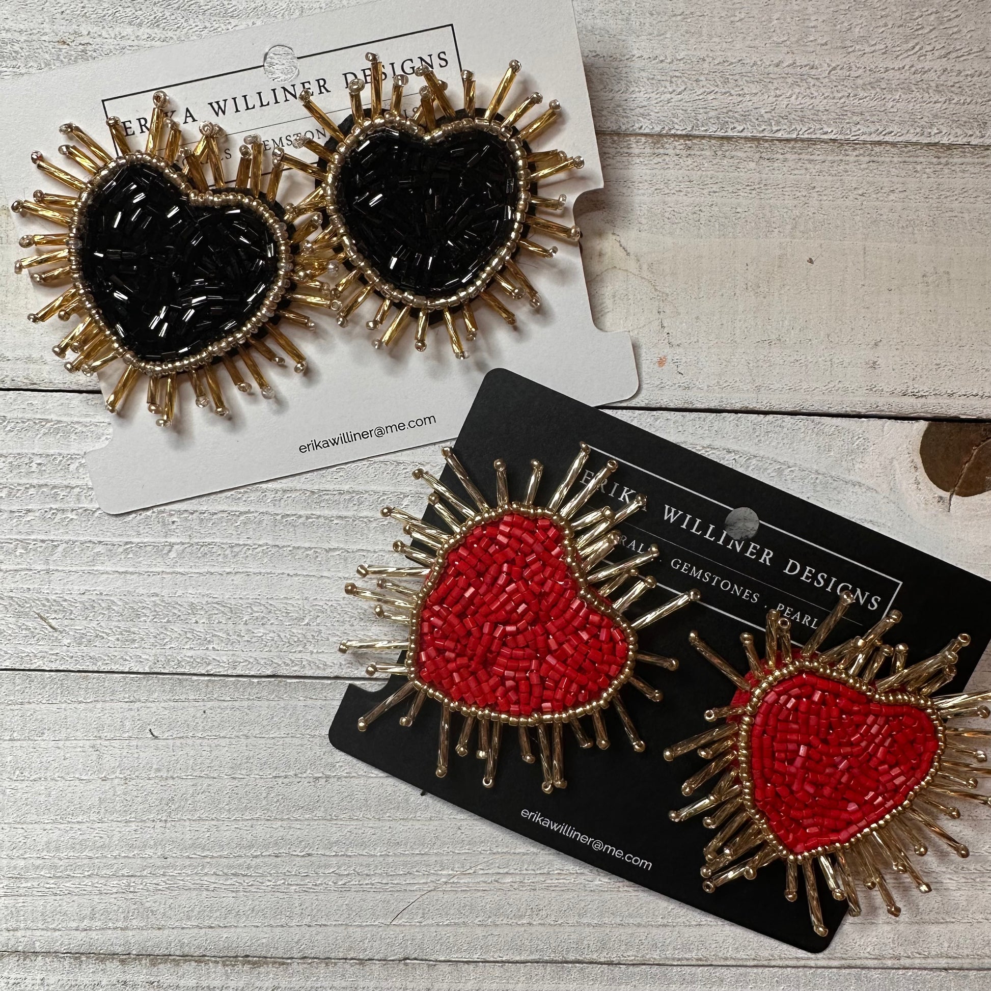 flat lay view of red and black heart earrings